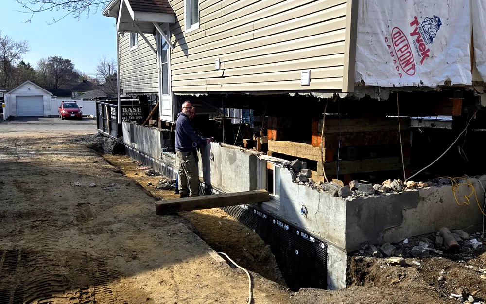 Ottawa house lifted on cribbing while a new foundation is replaced below