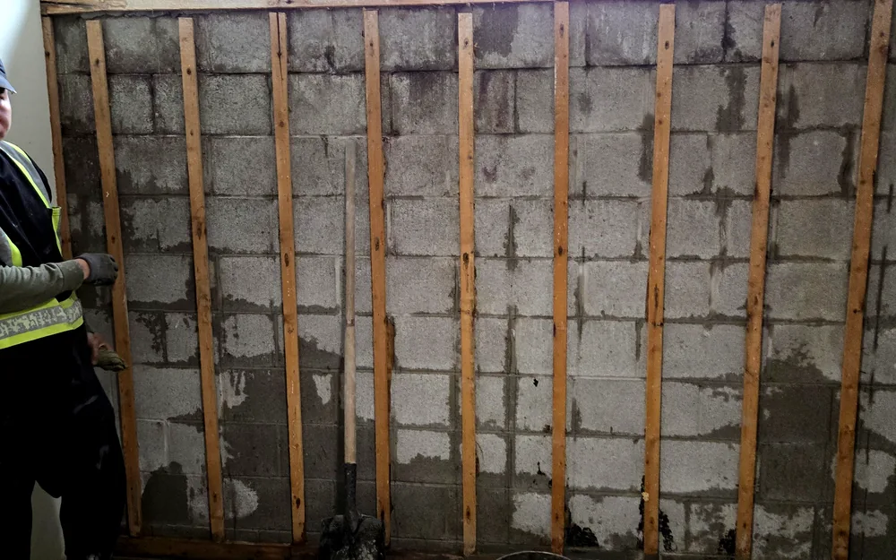 Interior basement wall reinforced with vertical bracing