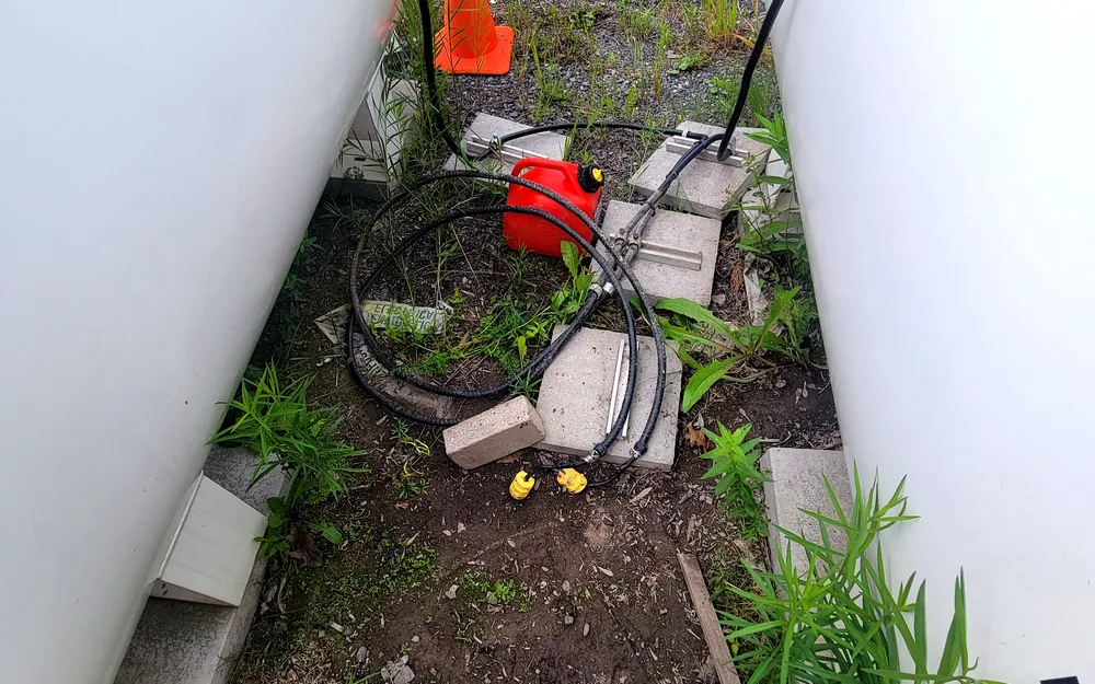 Sump pump and drainage hoses set up at an Ottawa job site